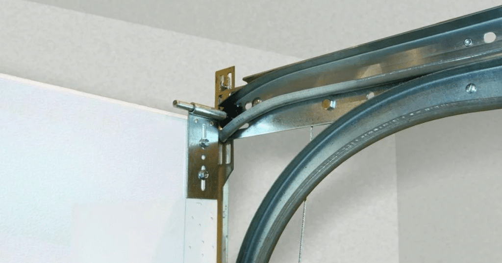 Close-up of a garage door track and metal bracket installation.