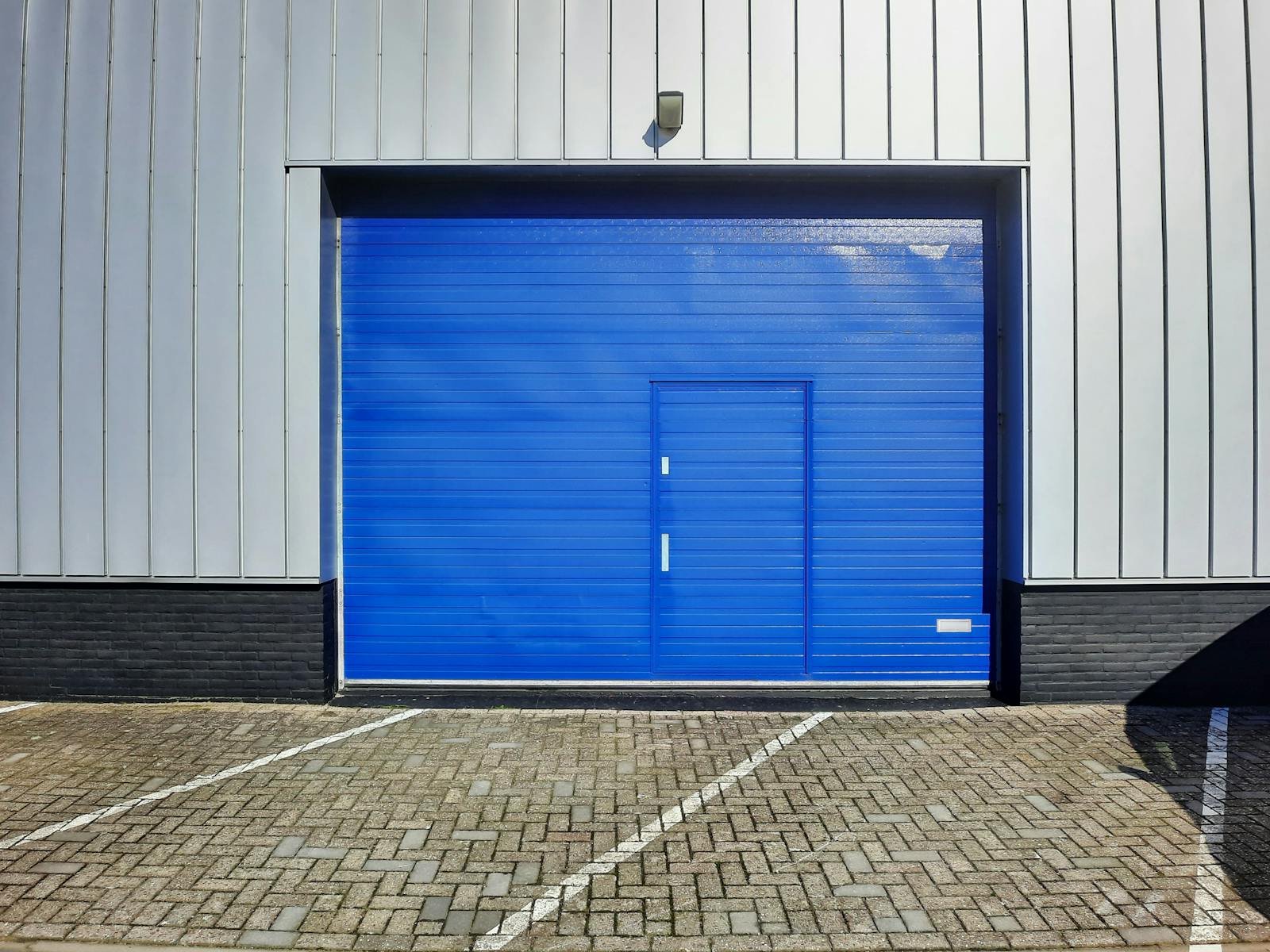 Blue commercial overhead door on an industrial building